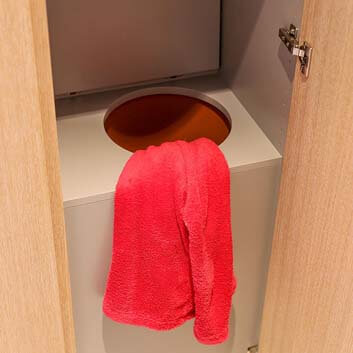 A laundry solution - a hidden passage in a wardrobe leading to the laundry room located below the bathroom