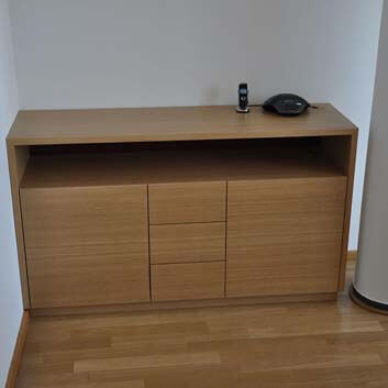 Wooden sideboard with open shelf, push-to-open doors, and drawers.