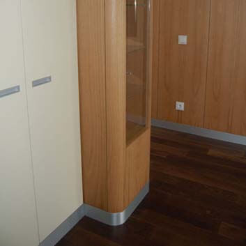 Curved display cabinet, wood-paneled walls