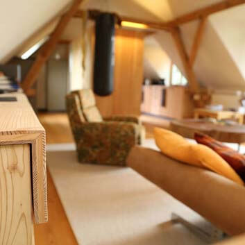 Close-up image of the natural wood sideboard with mitered edge on top.